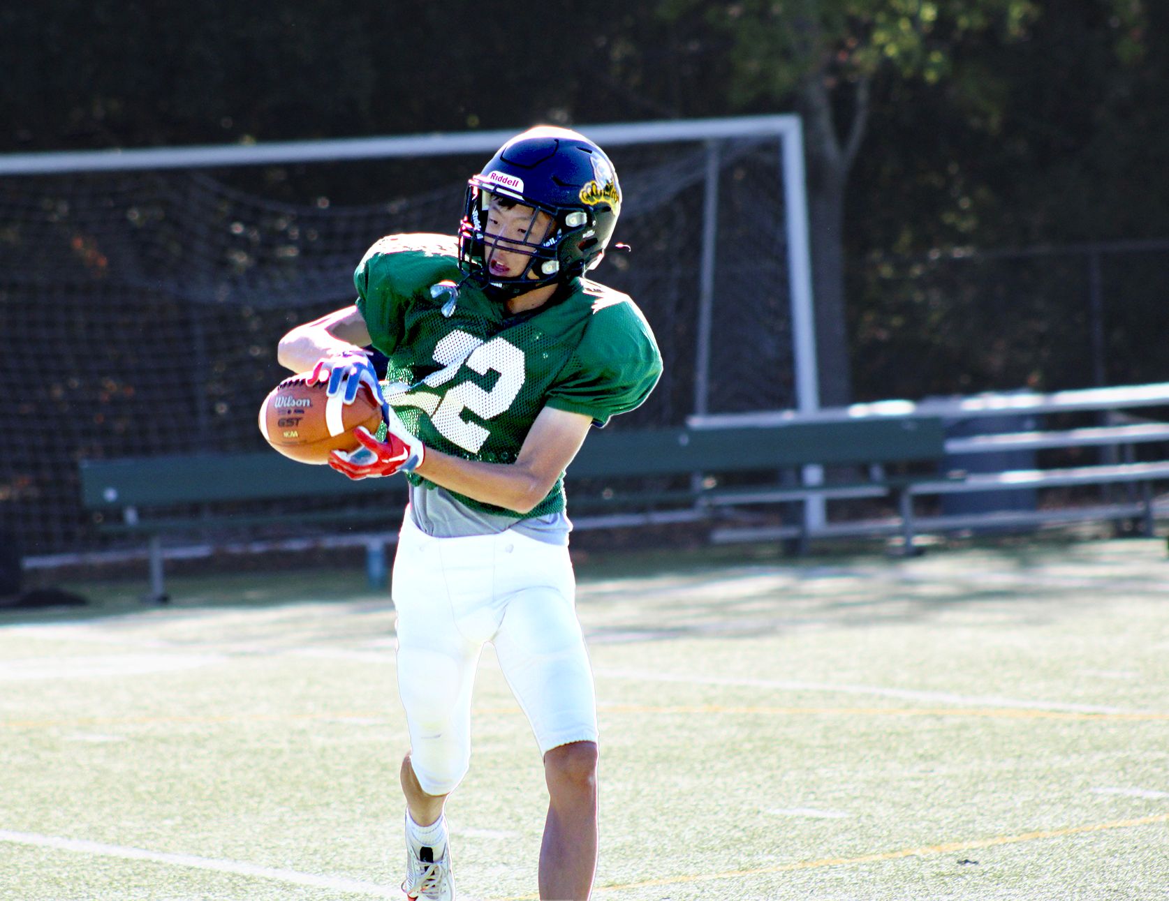 Brandon Ge catches football in stride during practice.