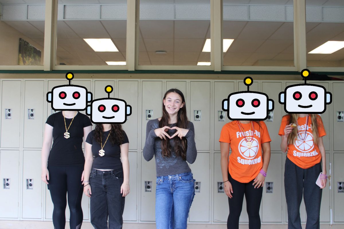 Junior Annabelle Eaton standing among claimed robot classmates.