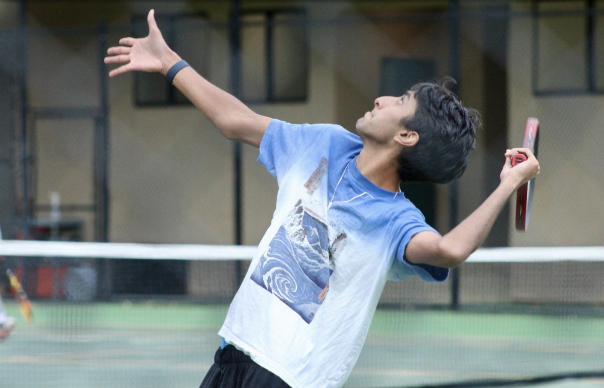 Junior Shay Mallempati serves during practice.