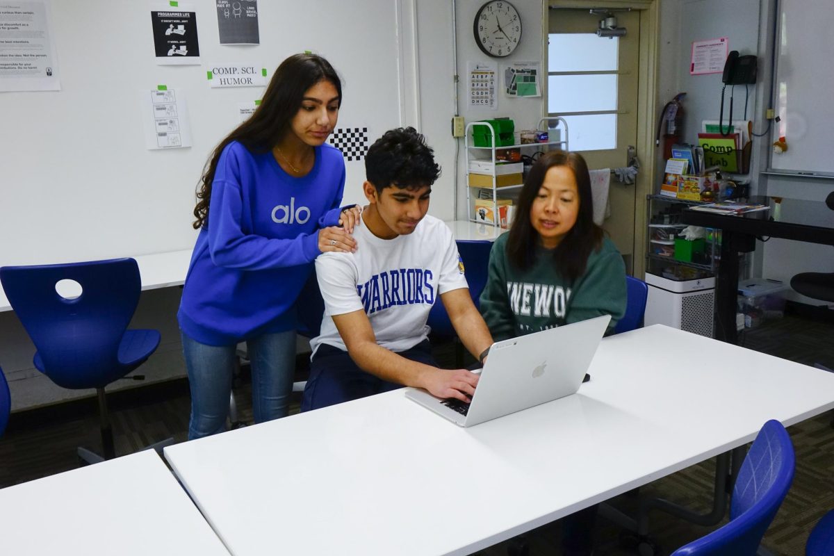 Budhani and her brother, Rafay collaborate on a computer science problem during a club meeting.