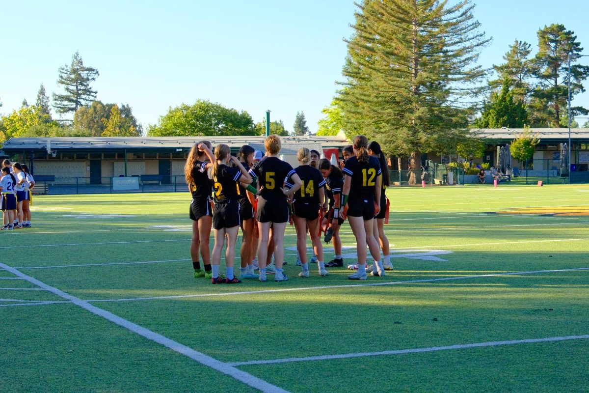 Girls Flag Football The team gathers for a huddle against NDSJ on 09/16.