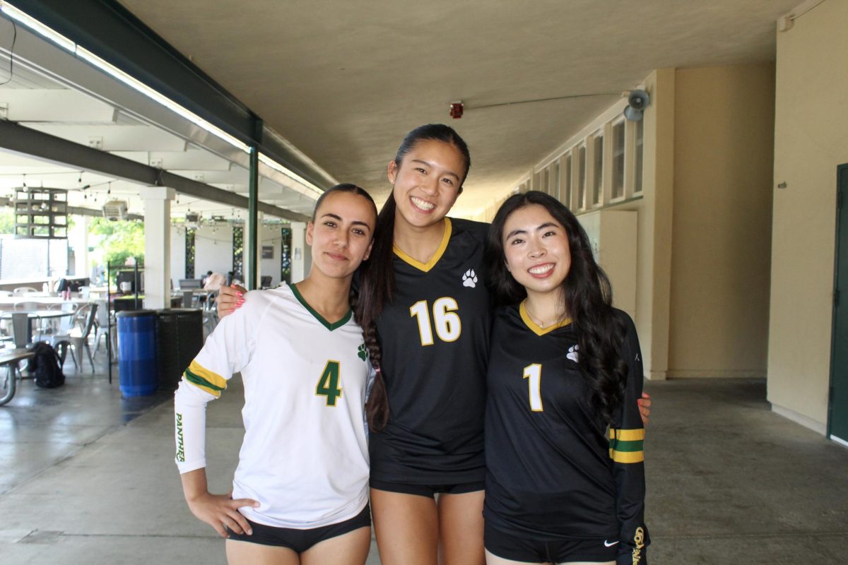 Volleyball Captains Abigail, Mailey, Caitlin (left to right) pose for a photo